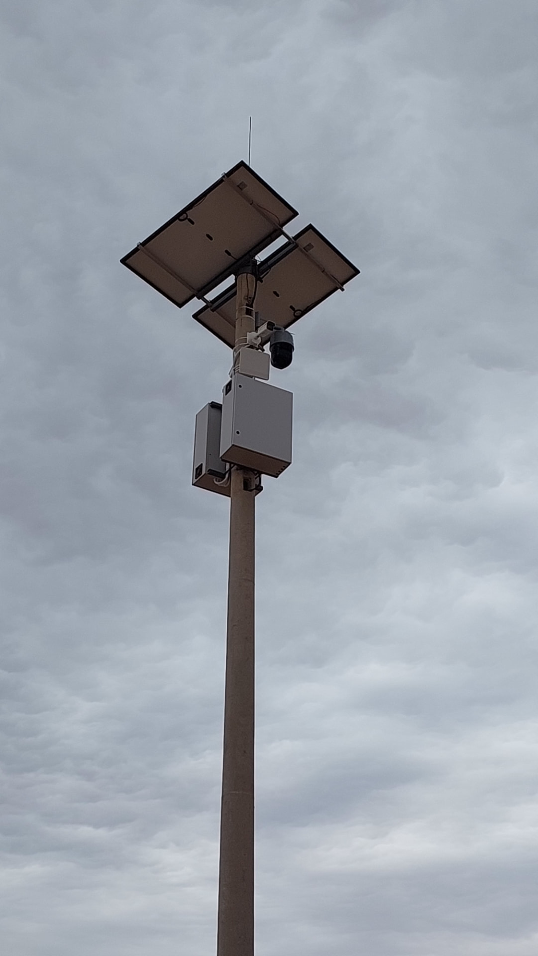 CCTV surveillance pole powered by mounted solar panels