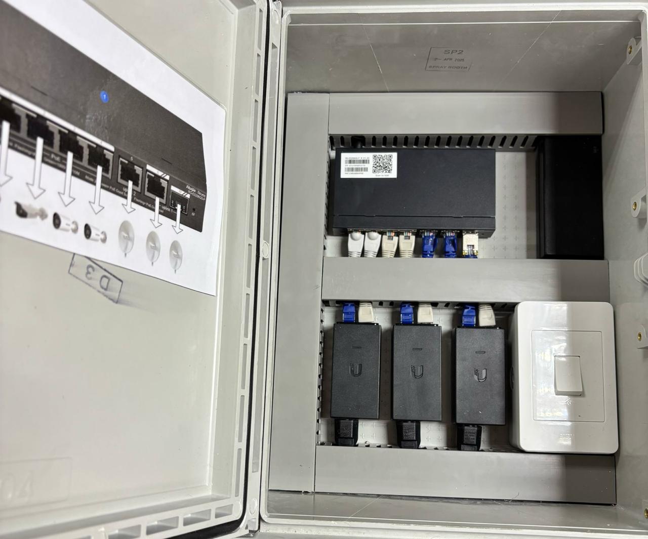 Network switch, PoE injectors and power neatly installed inside a weatherproof cabinet