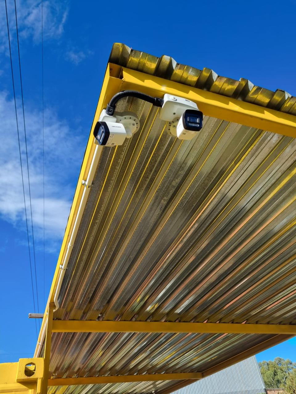 Hikvision security cameras mounted under a covered structure