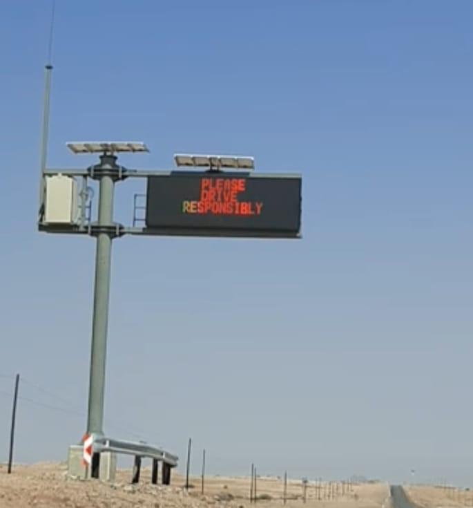 Solar-powered LED road sign displaying a road safety message